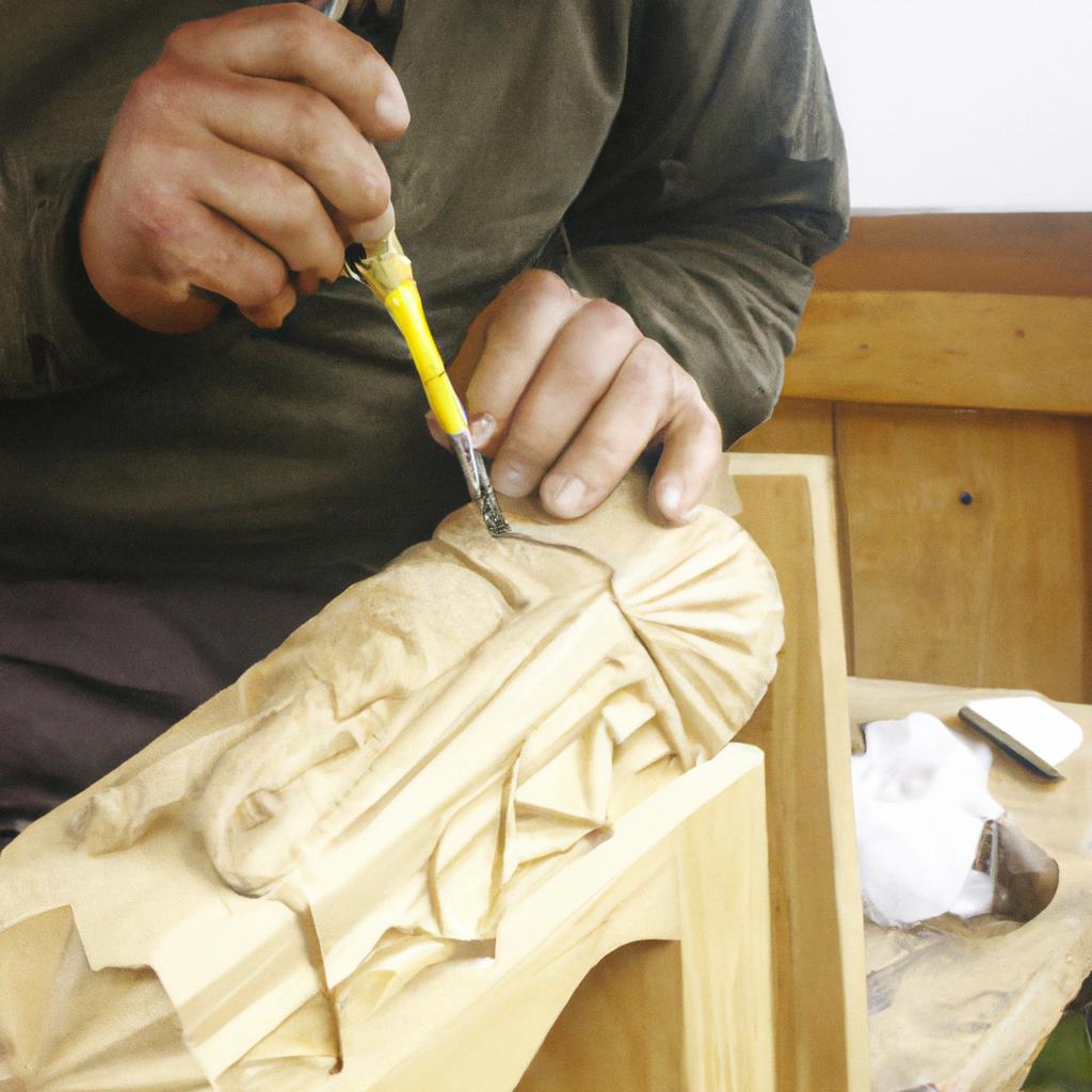 Person carving intricate wooden design